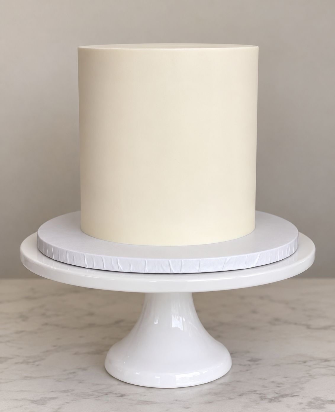 Smooth white sharp-edge buttercream cake ready for toppers